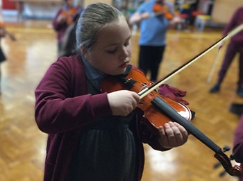 Primary school girl playing violin